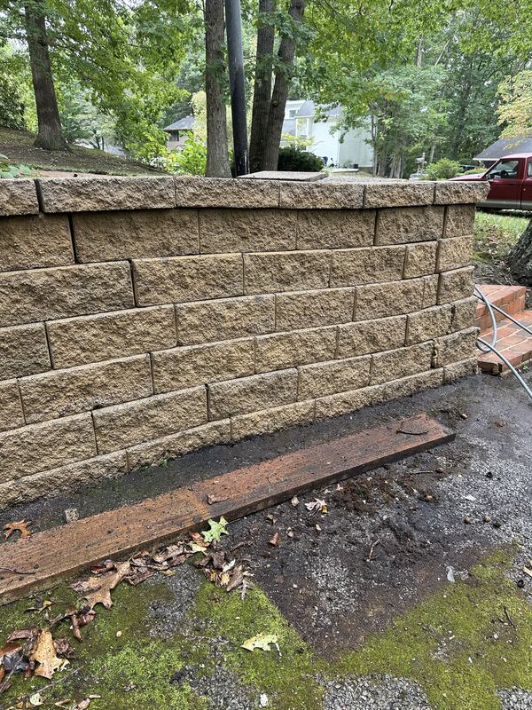 Clean retaining wall after pressure washing